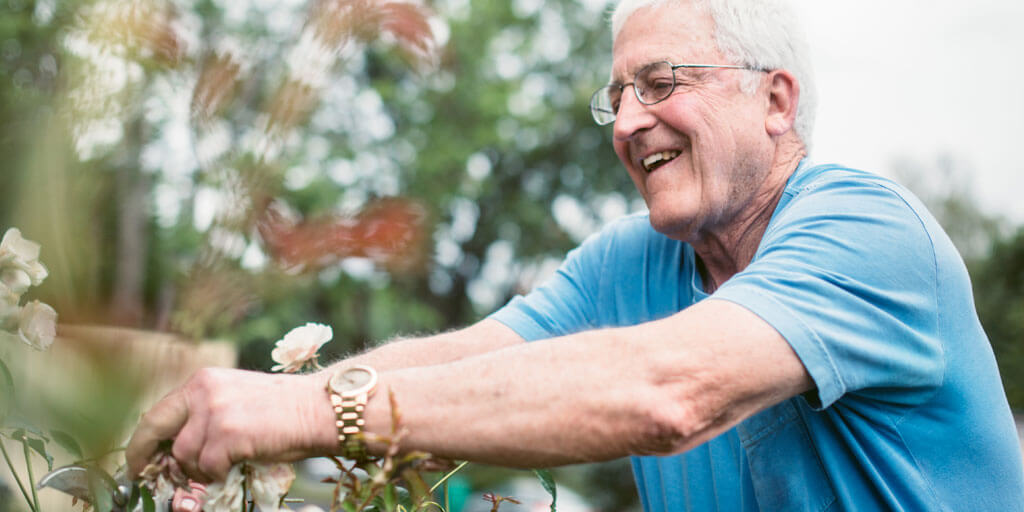 Senior man outside gardening