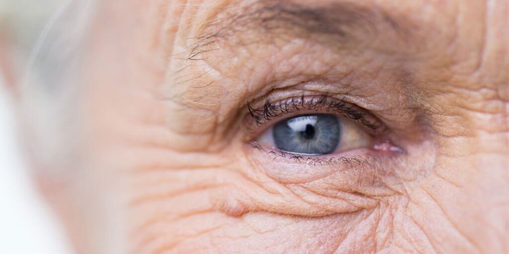 Senior woman's eye flooded with light. Within reason, bright light will not damage your eyes.